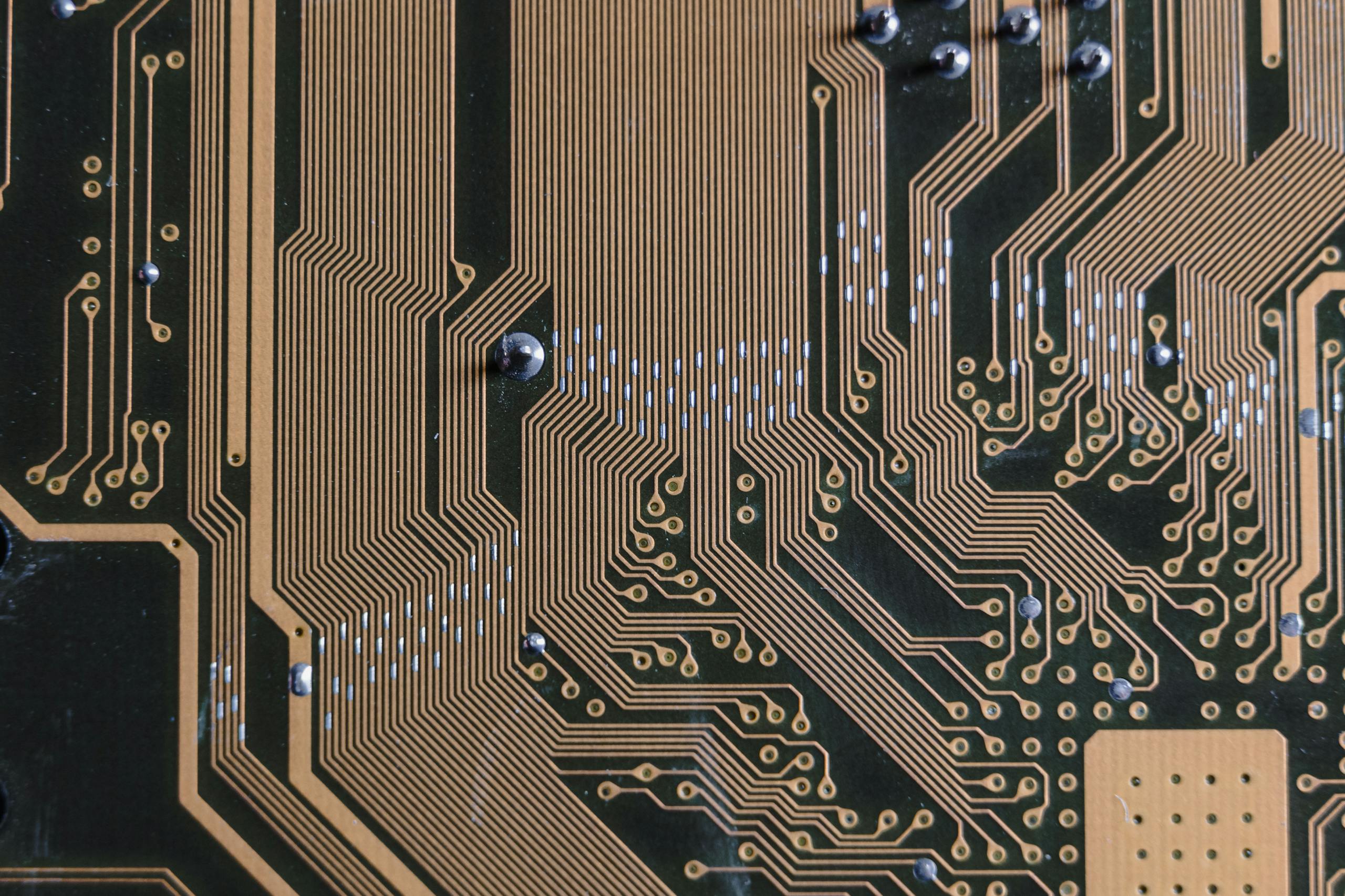 Detailed view of a circuit board with intricate gold traces.
